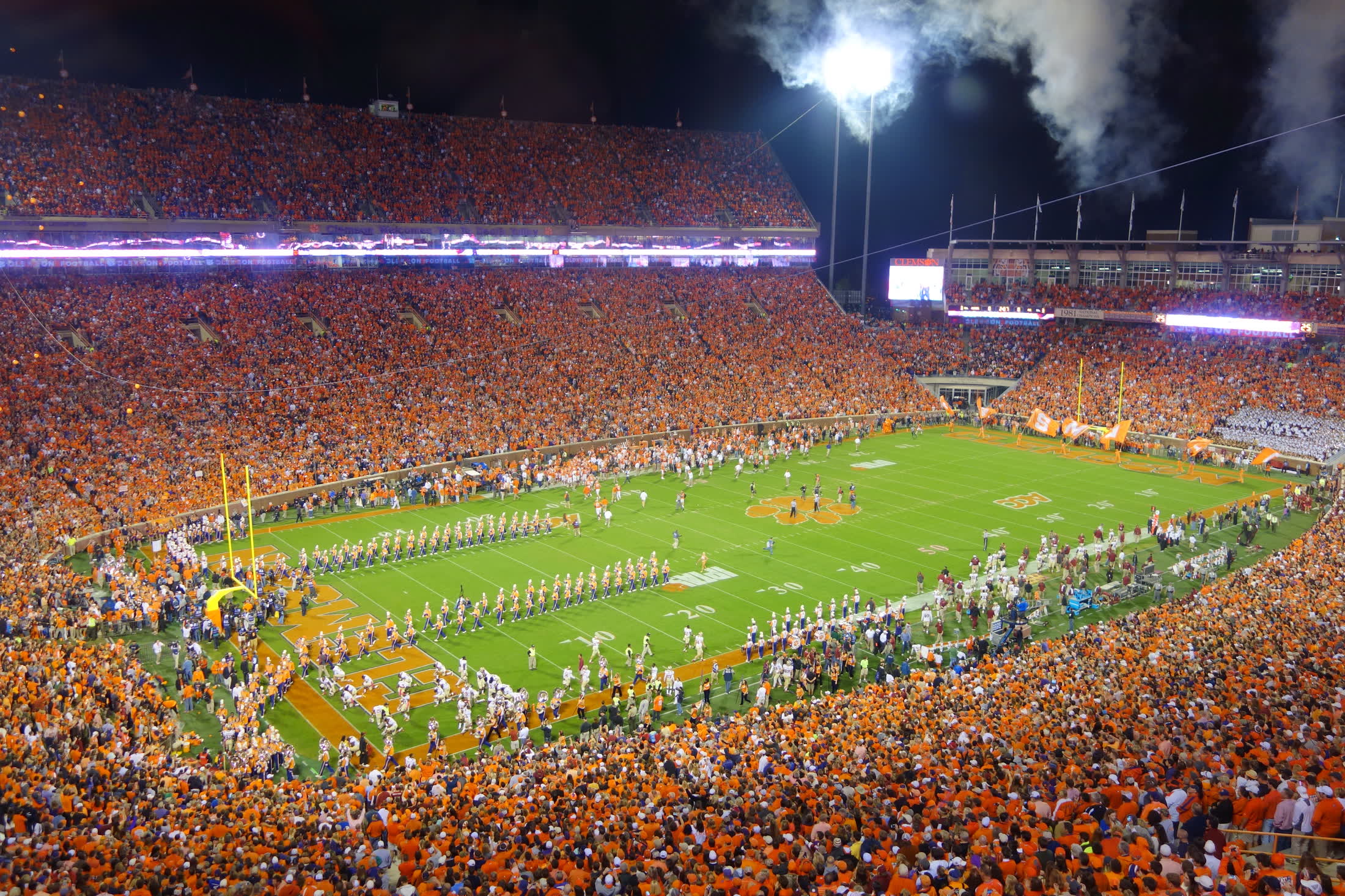 Clemson Memorial Stadium at night, the stands full under the lights